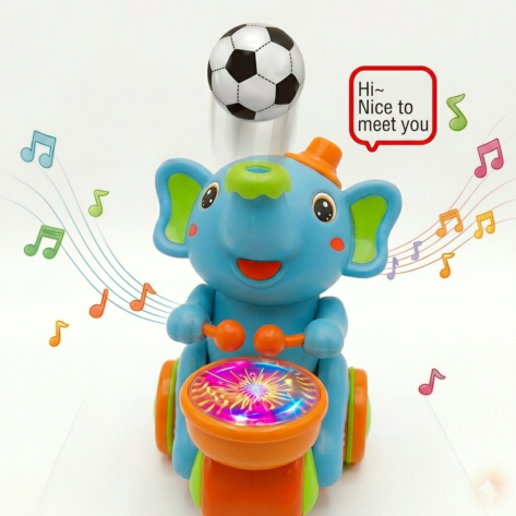 Blue cartoon elephant toy with green ears and orange hat, riding an orange light-up scooter while balancing a black-and-white soccer ball on its trunk, surrounded by colorful musical notes and a speech bubble that says “Hi~ Nice to meet you” (toywala.pk)